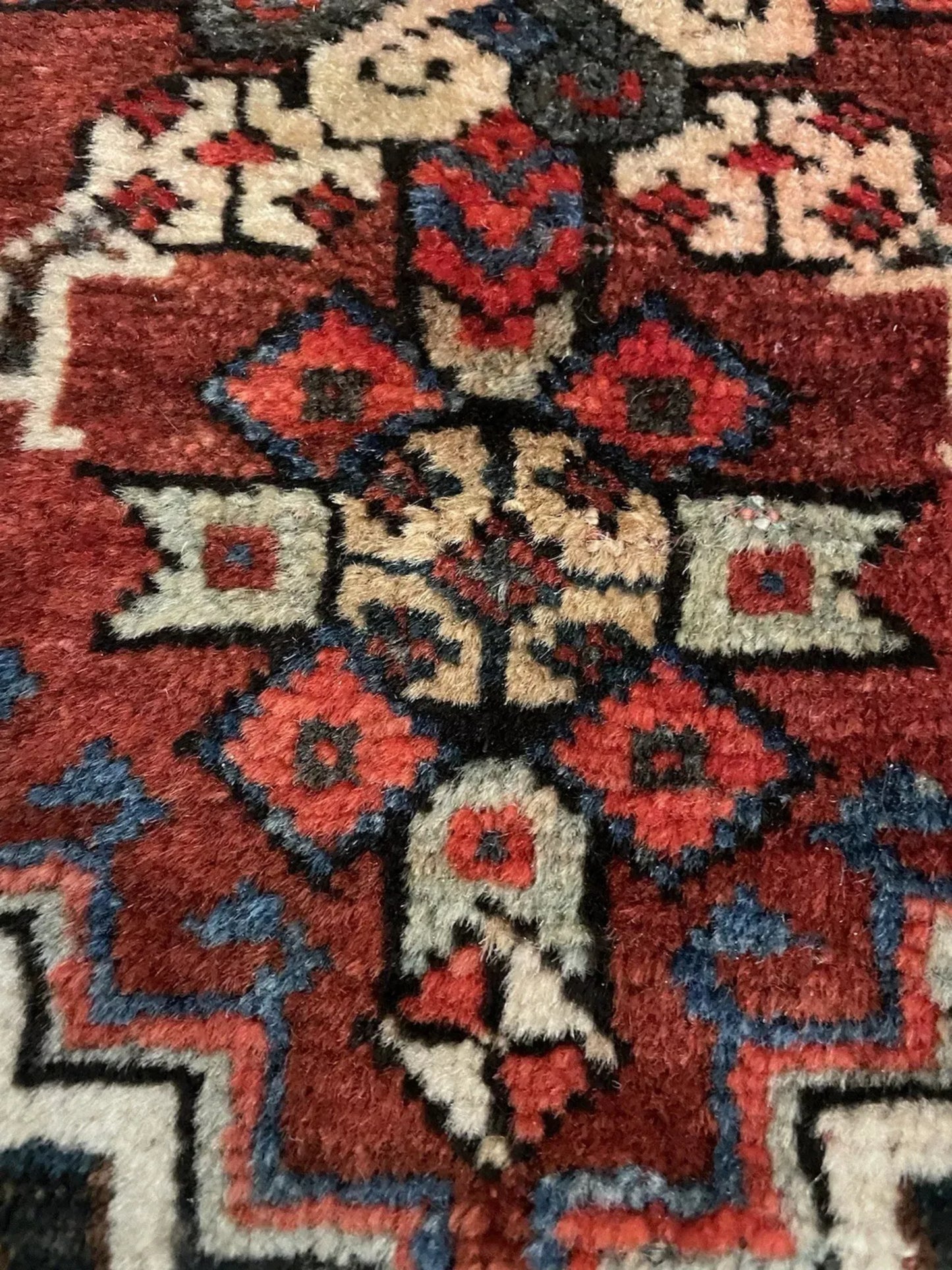 Deep red background with indigo and saffron patterns

