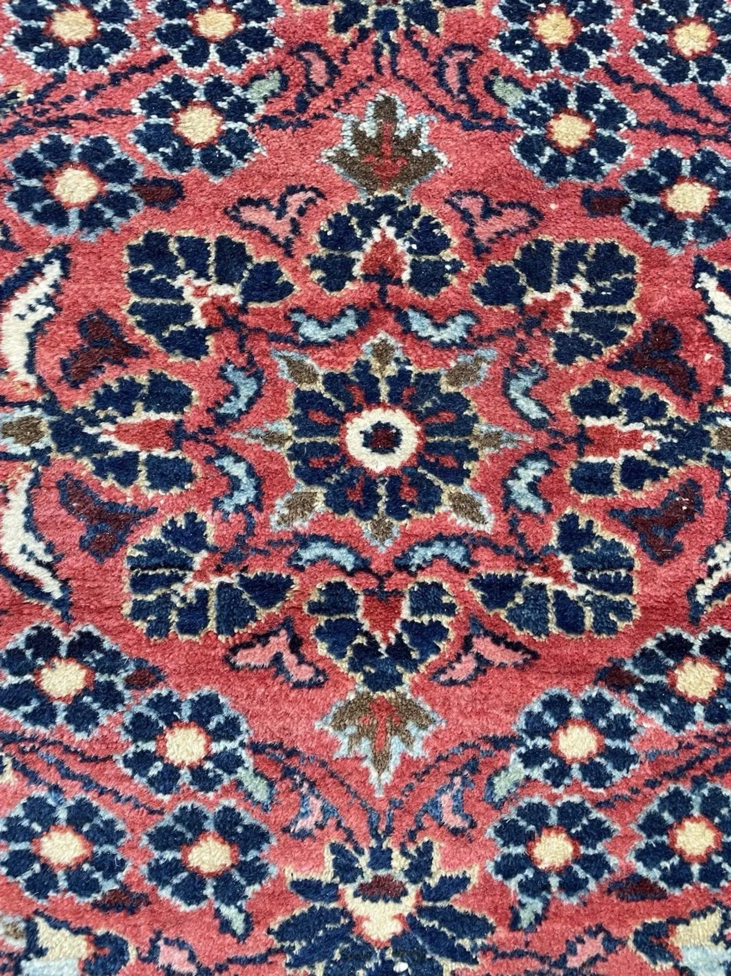 Navy blue accents defining floral motifs

