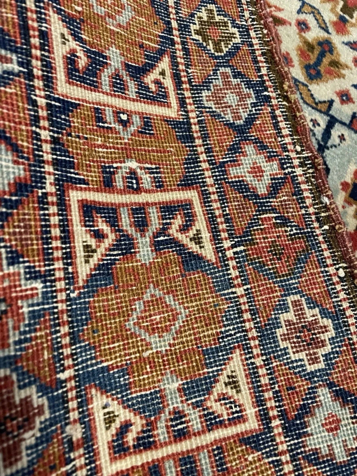 Stylized diamonds and latch-hooks on blue field

