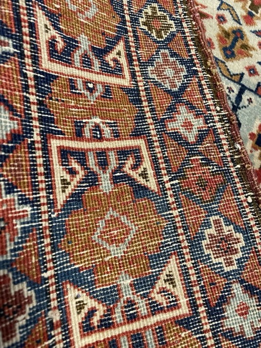 Stylized diamonds and latch-hooks on blue field

