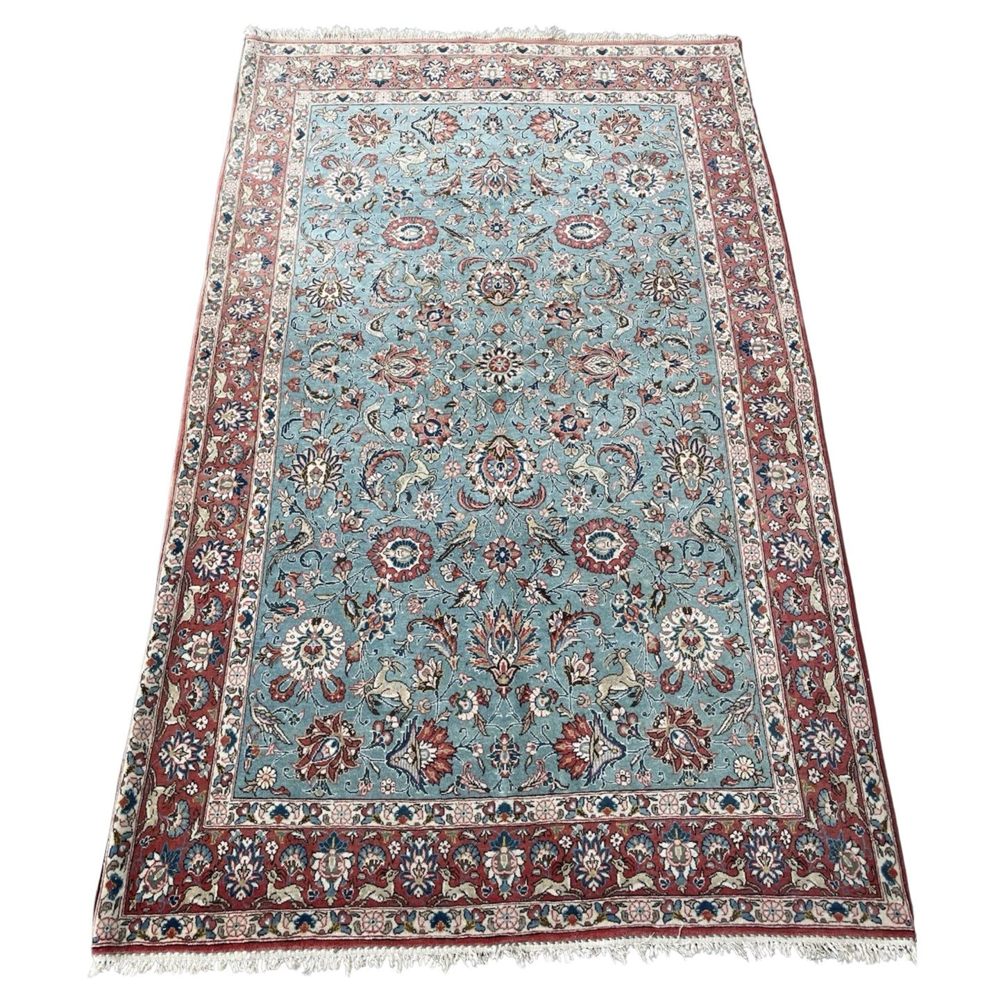 Antique Kazvin rug with floral and animal motifs on aqua field

