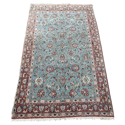 Antique Kazvin rug with floral and animal motifs on aqua field

