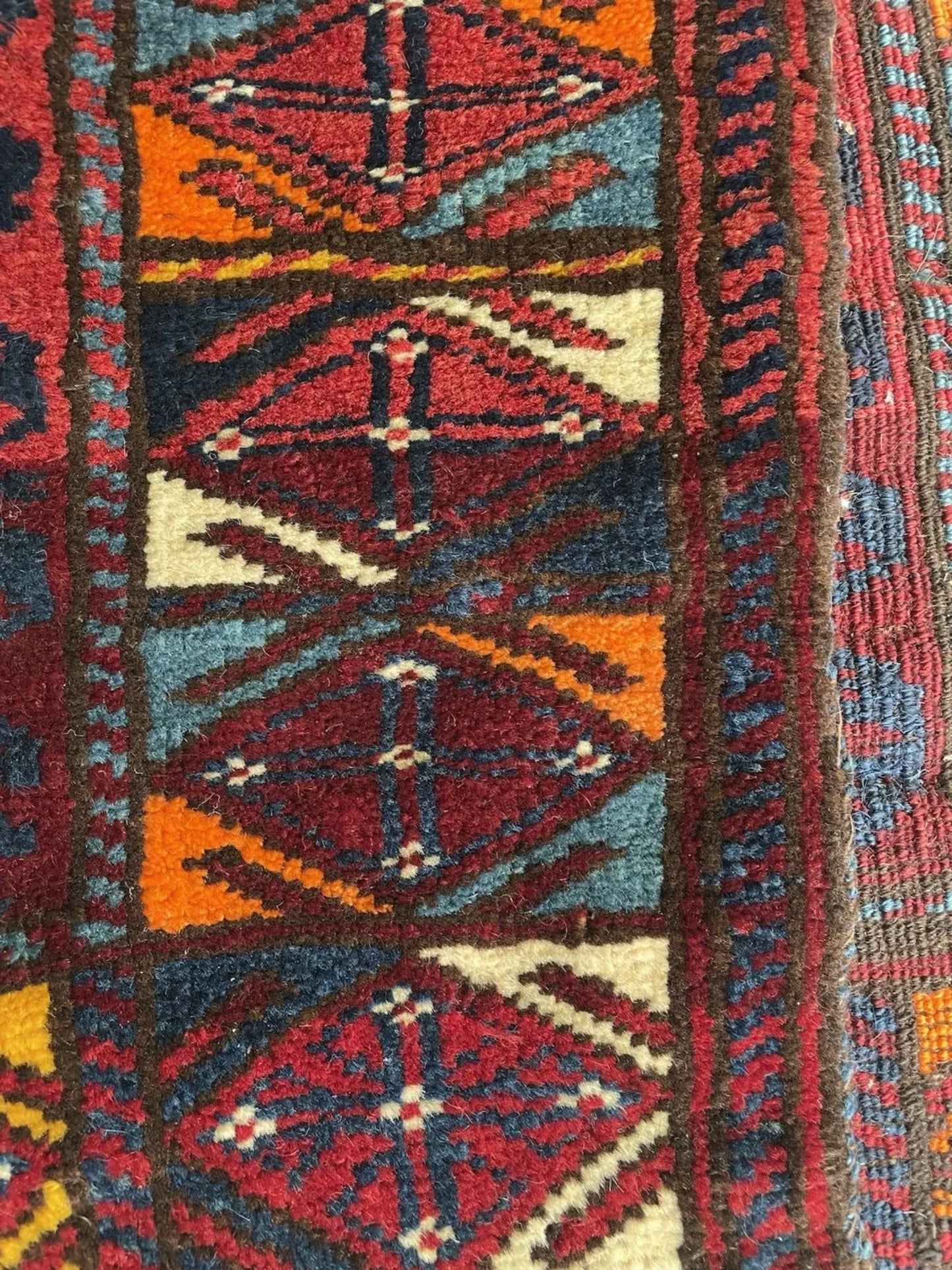 Color contrast between crimson field and blue motifs

