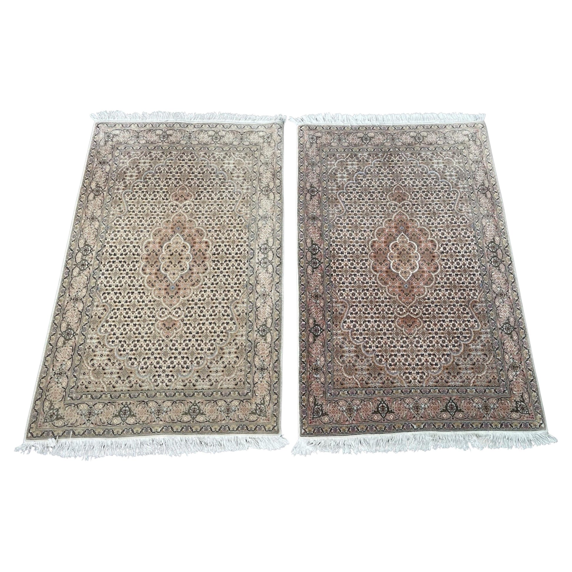 Pair of vintage Tabriz rugs with floral medallion designs

