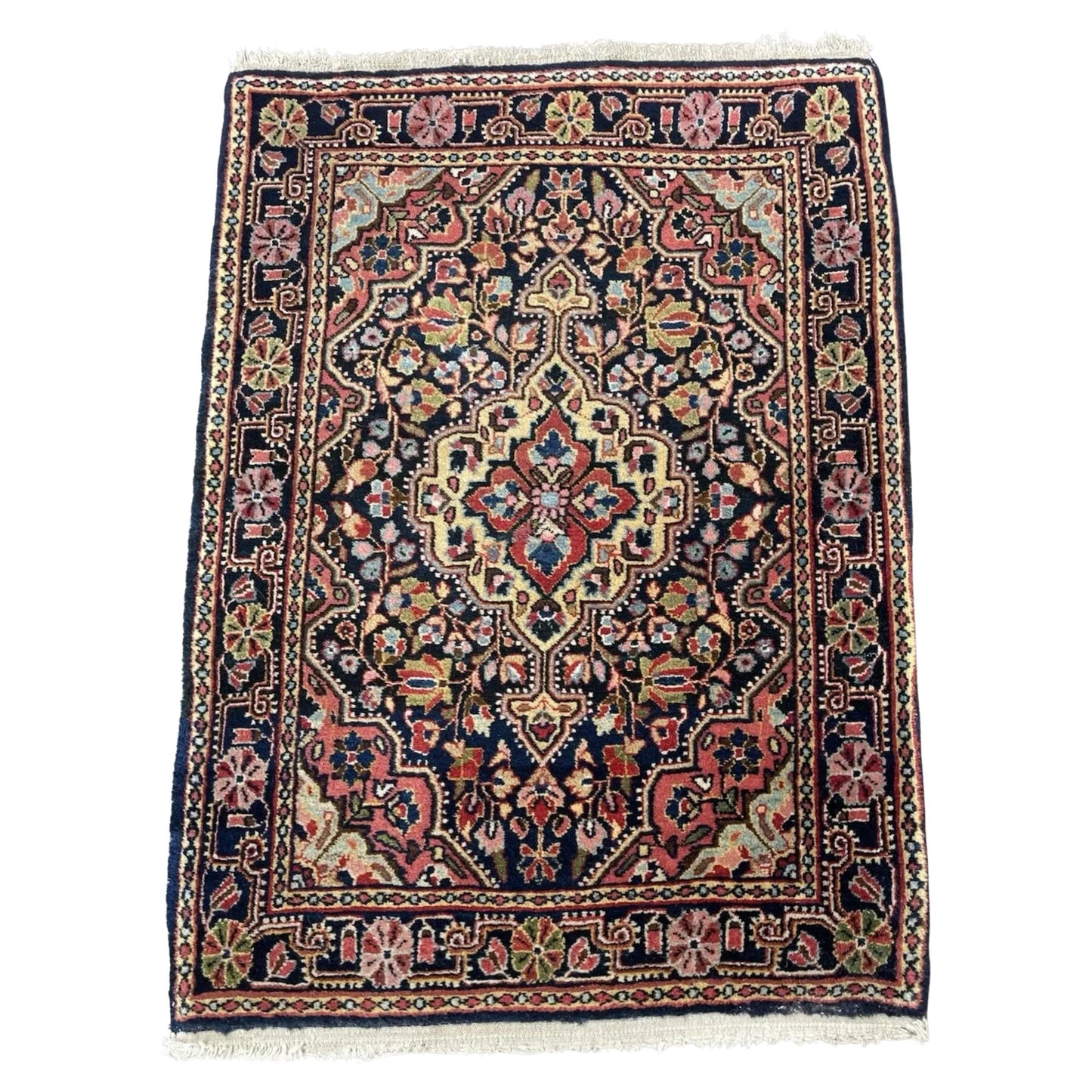Antique Jozan Sarouk rug with floral medallion on navy field

