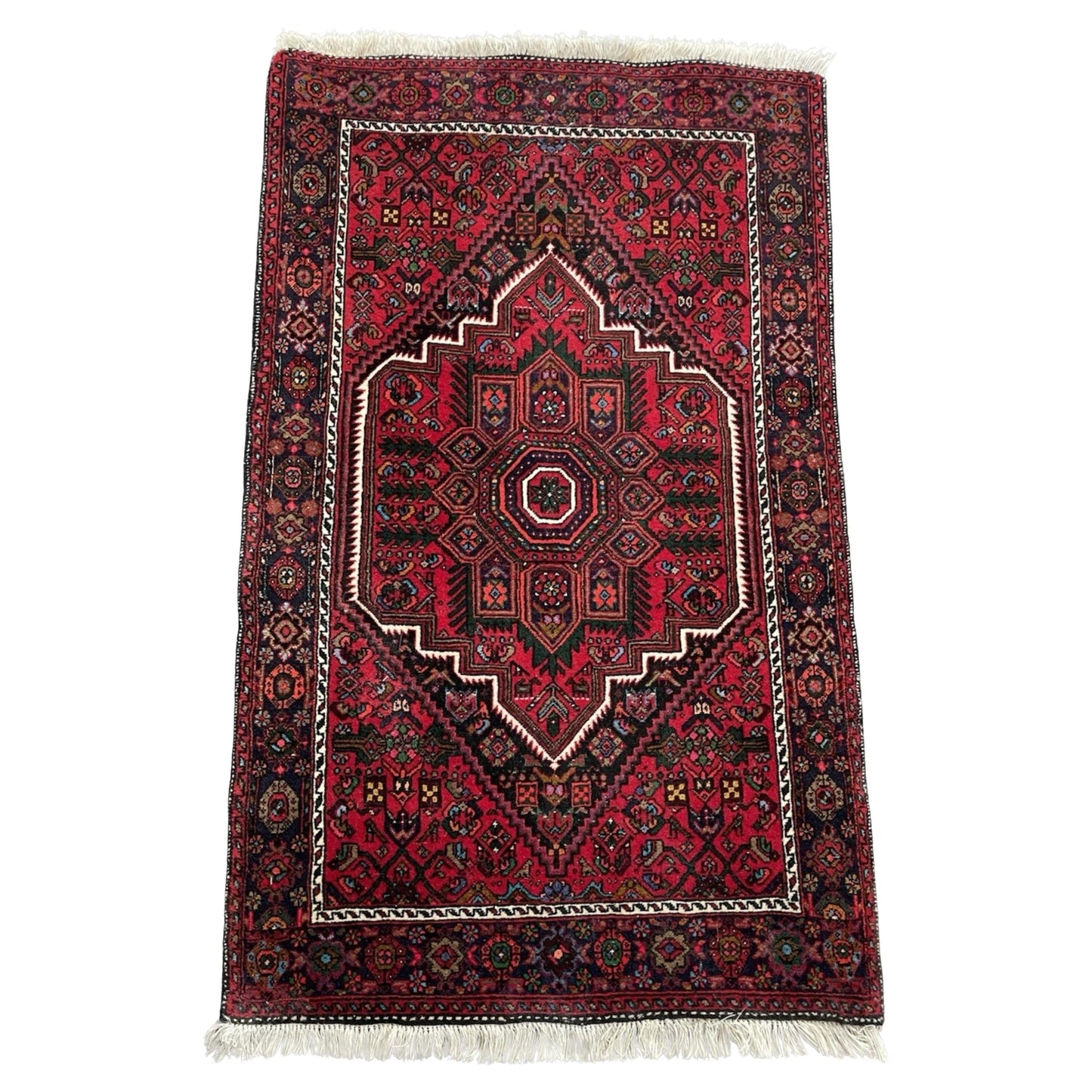 Vintage Hamadan rug with geometric medallion on red field

