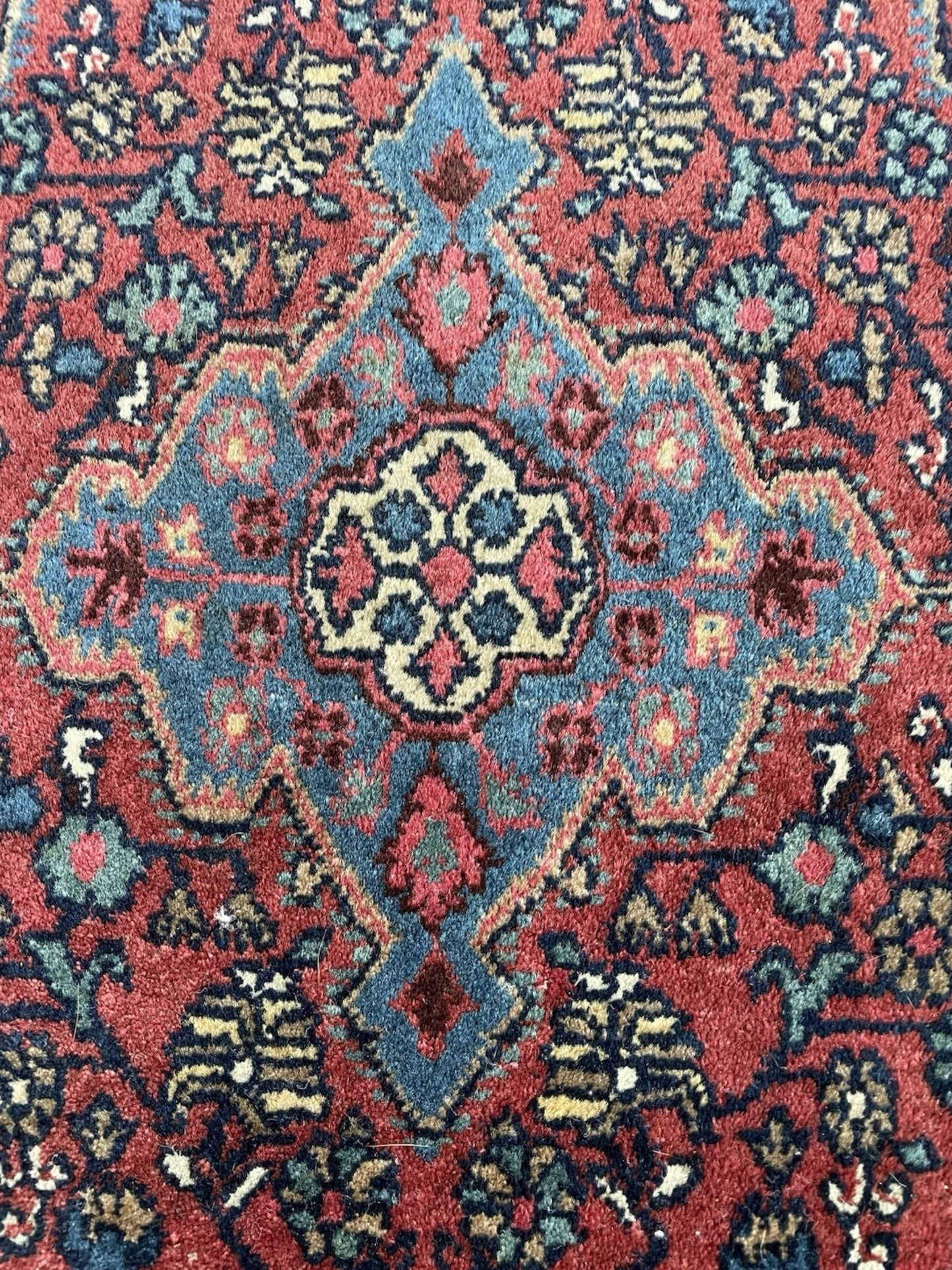 Macro detail showing the individual hand-tied knots on the rug's back.

