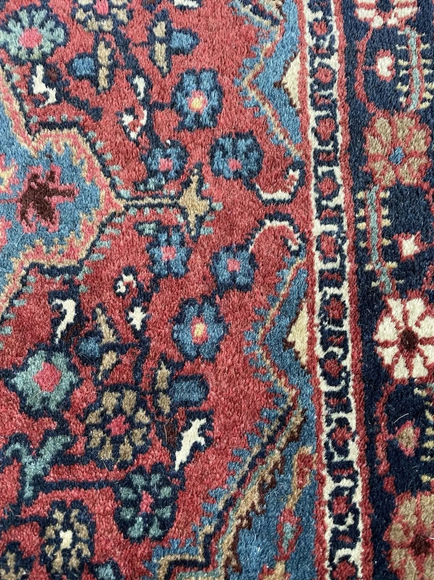 Side angle view showing the rug's thick pile and sturdy cotton foundation.

