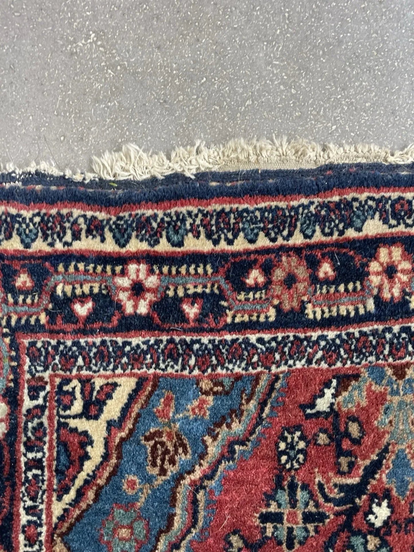 Close-up capturing the color contrast between deep red, navy, and cream.

