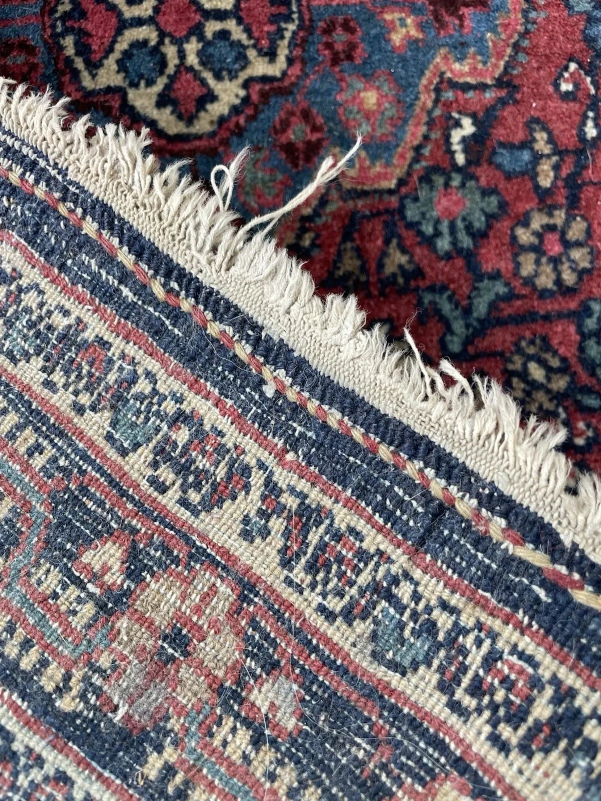 The Hamadan mat displayed on a hardwood floor to illustrate its size.

