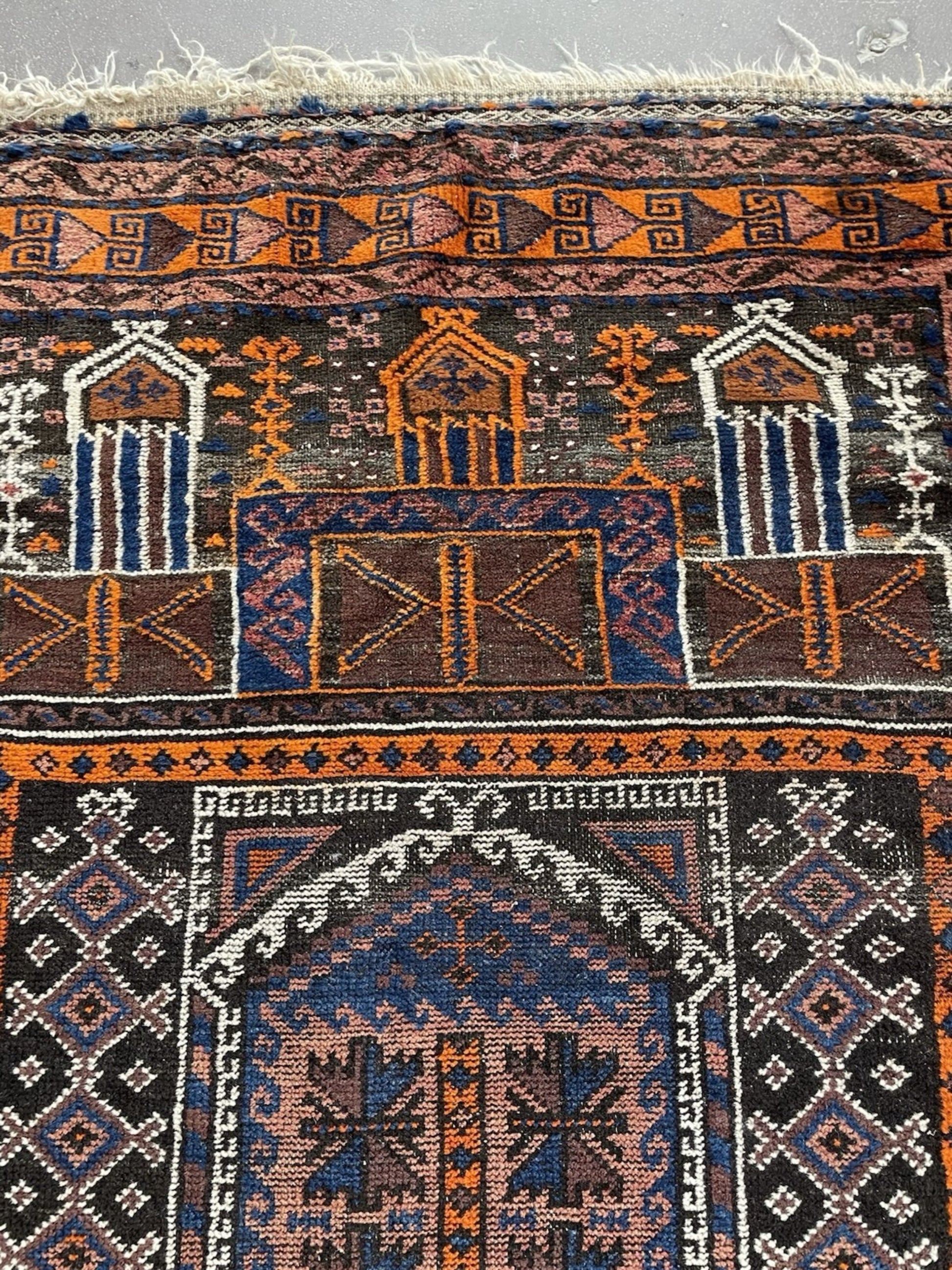 The back of the prayer rug showing the dense hand-knotted construction.

