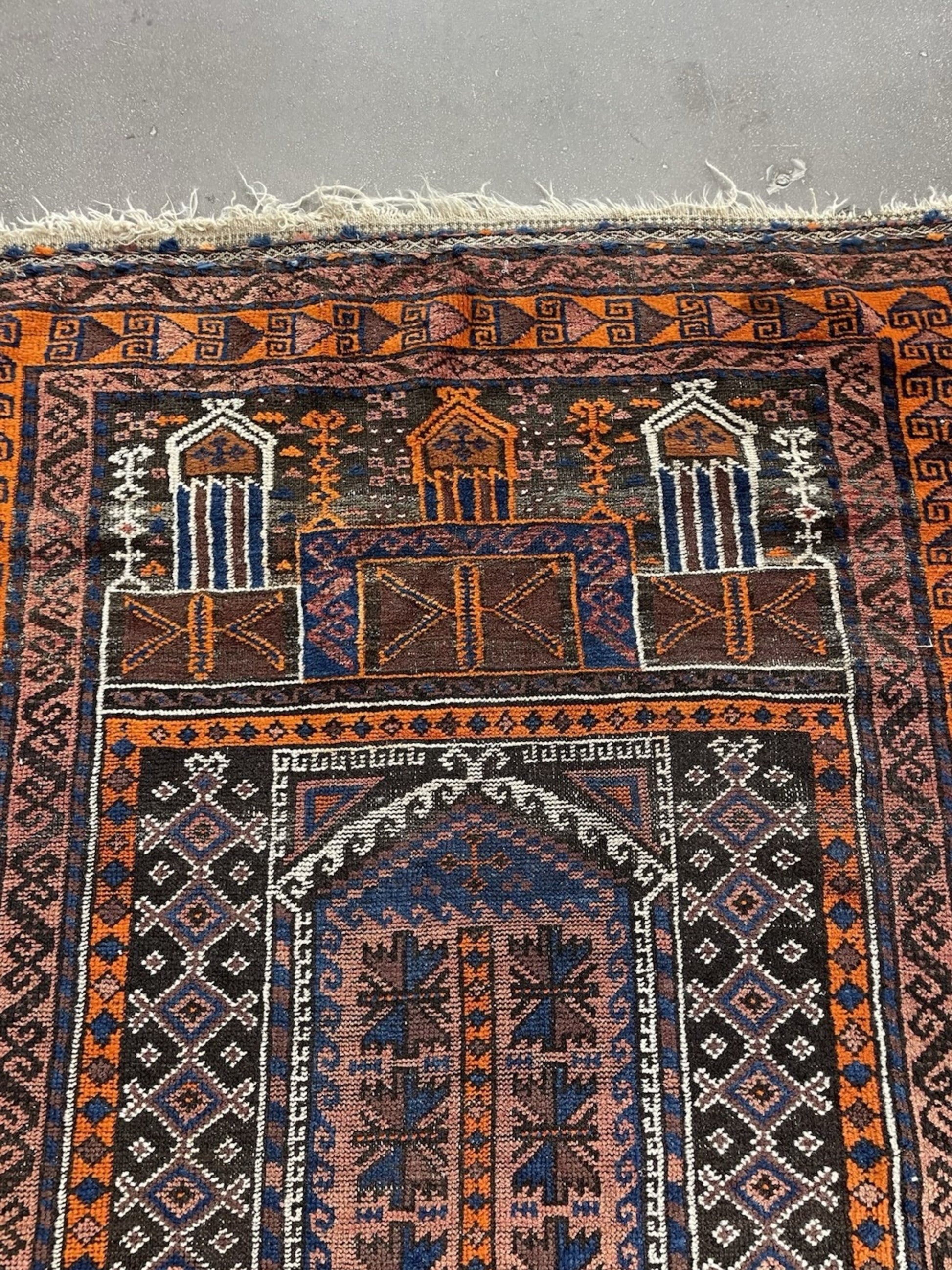 Close-up of the fringe and one end of the antique Baluch rug.

