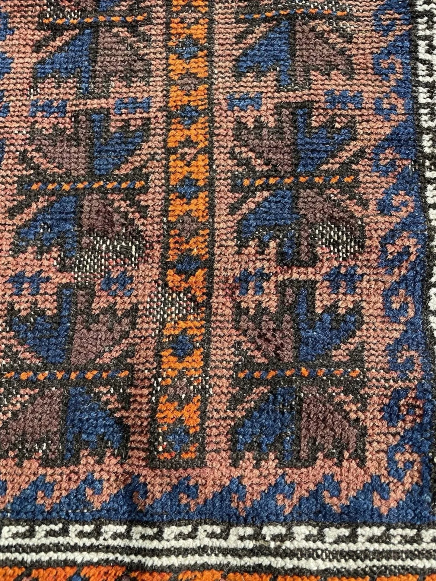 Close-up capturing the deep burgundy red and terracotta orange hues.

