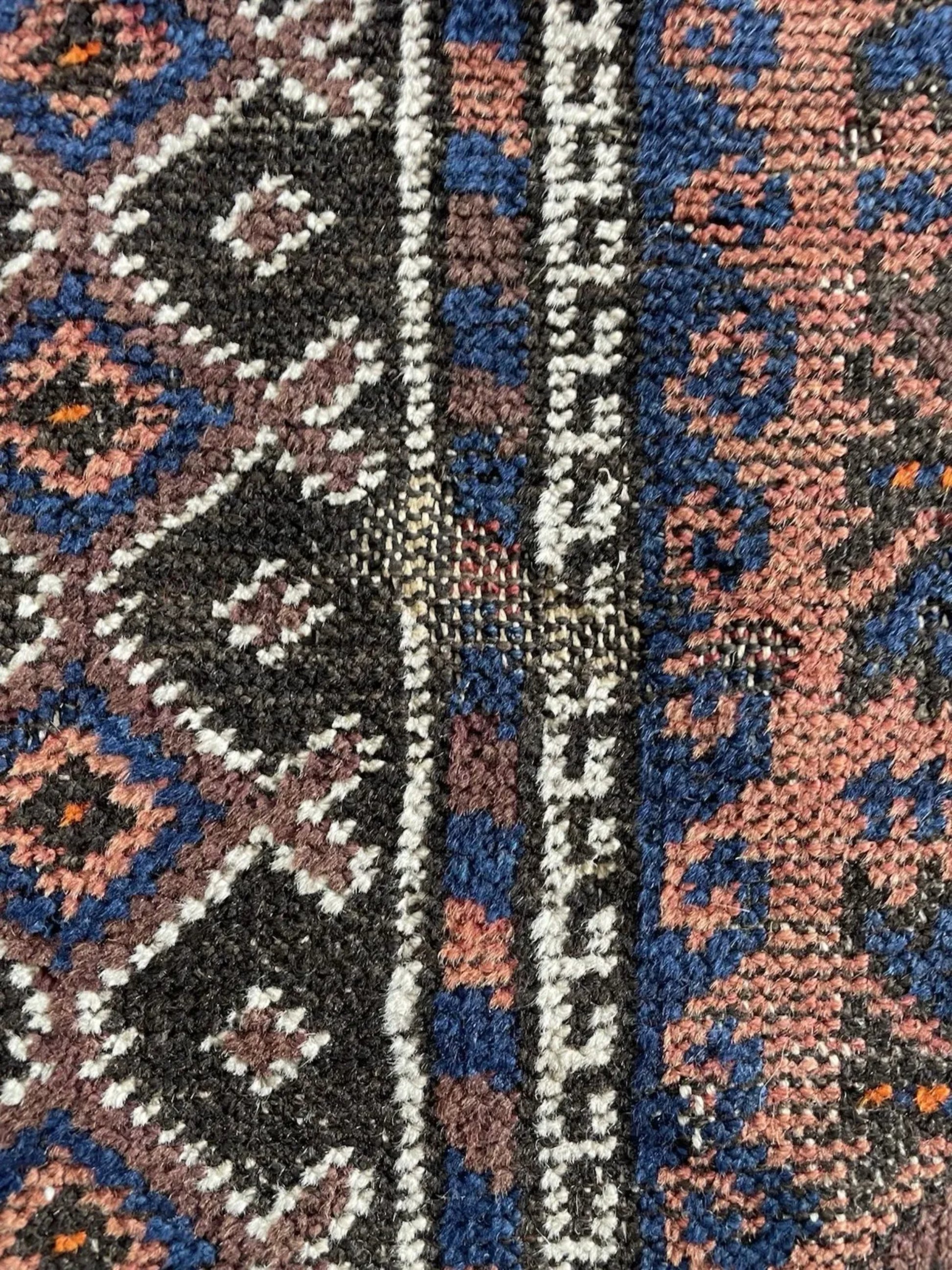 The prayer rug displayed to highlight its symmetrical sacred design.


