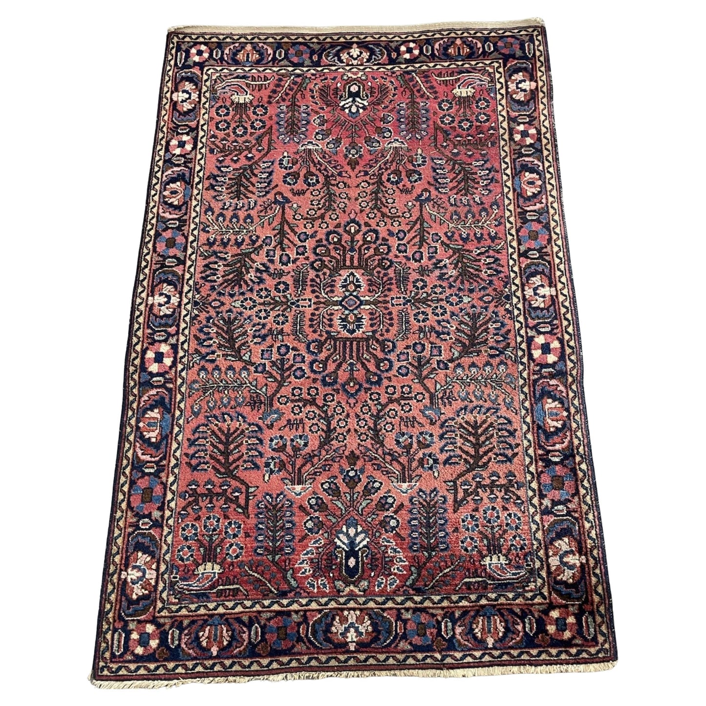 Full front view of the antique Persian Sarouk rug showing the overall floral design.

