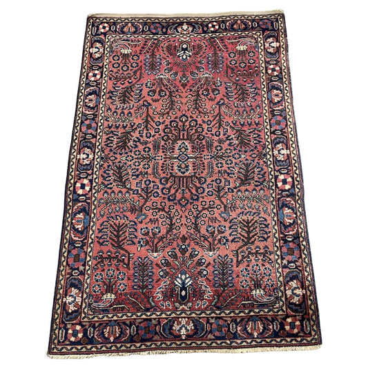 Full front view of the antique Persian Sarouk rug showing the overall floral design.

