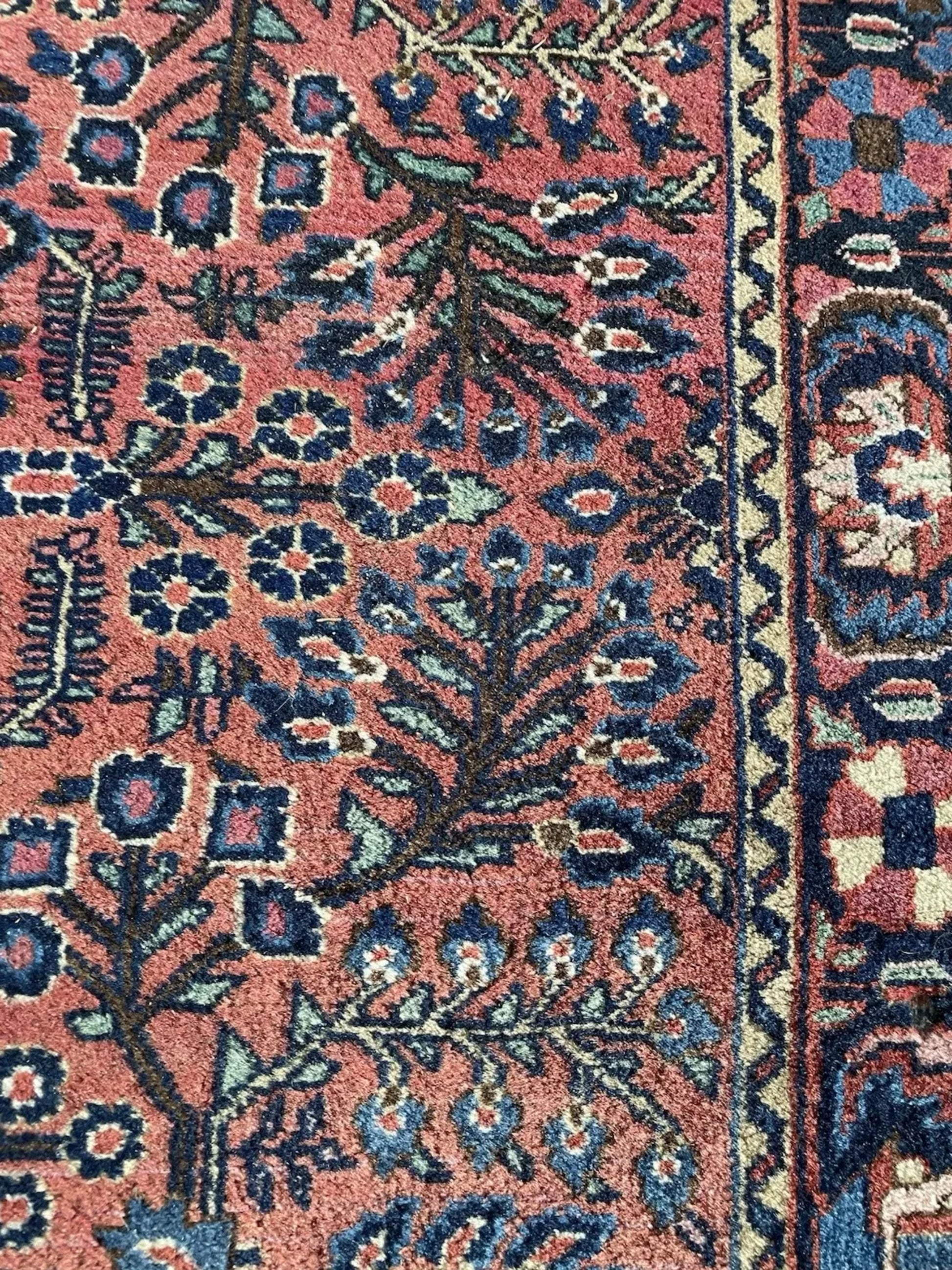 Detailed shot of the multi-layered border with floral and vine motifs.

