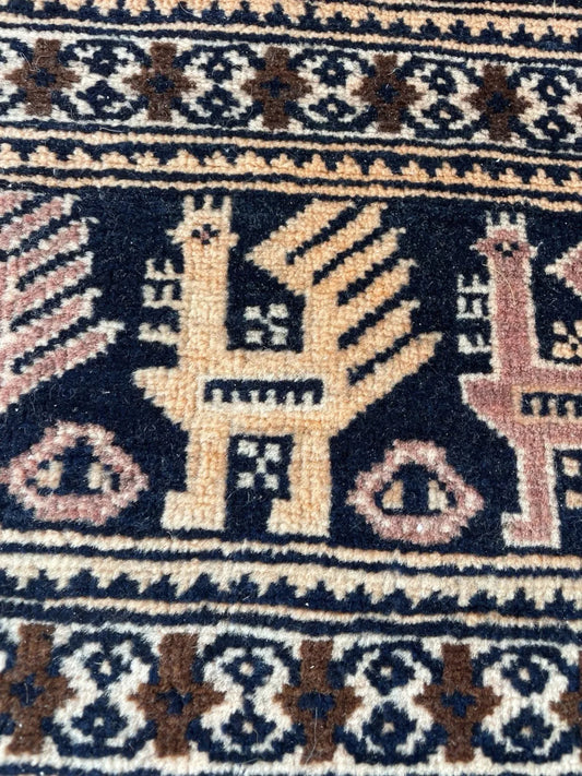 Close-up detail of the bold tribal motifs on the burgundy field.

