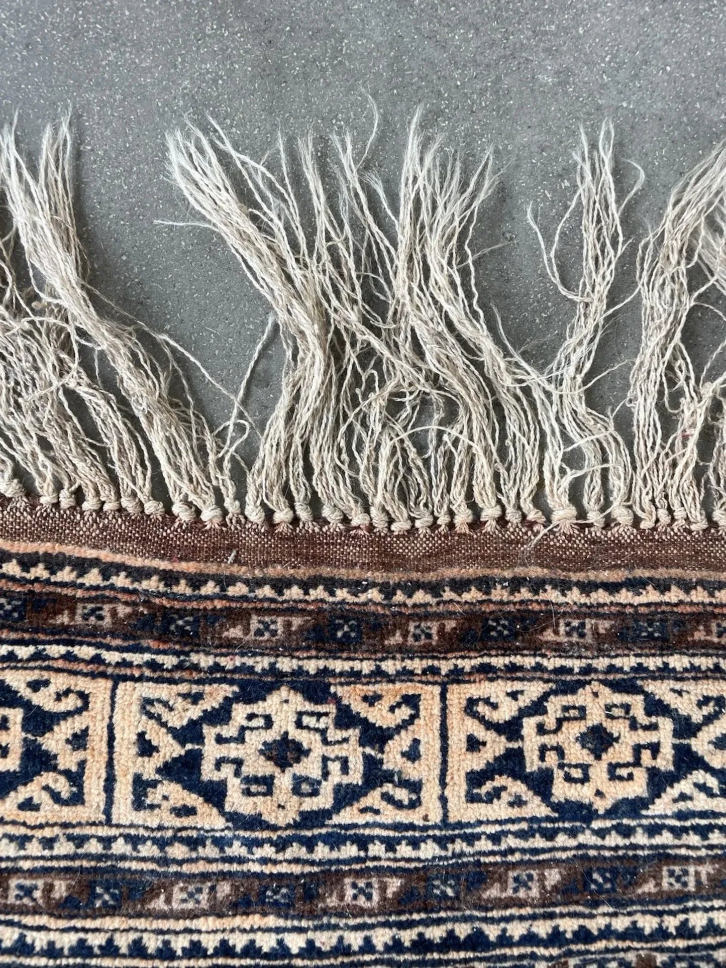 Macro shot of the hand-knotted wool texture and intricate design details.

