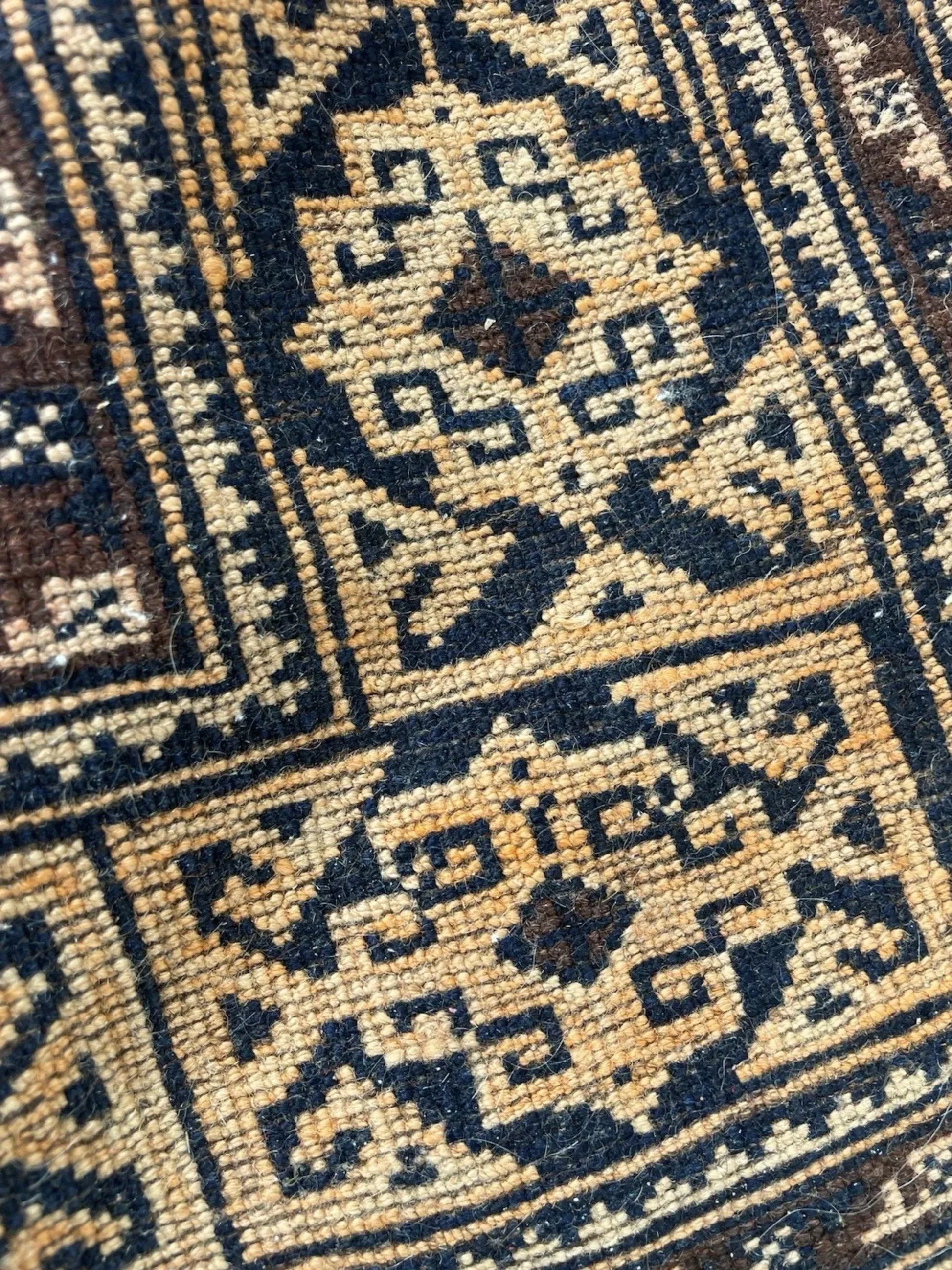 Diagonal angle view highlighting the rug's rectangular shape and borders.

