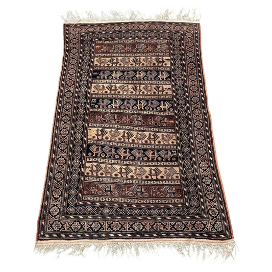 Handmade antique Afghan Baluch wool rug from the 1920s featuring repeating tribal bands with stylized animals and tree-of-life motifs.

