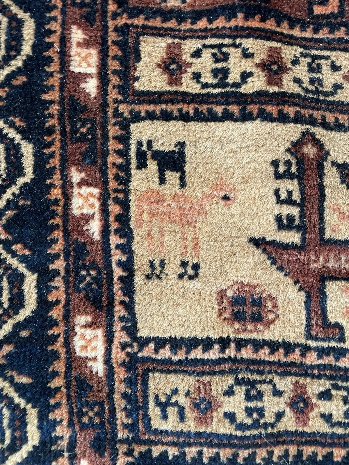 Antique Baluch rug measuring 4.3 x 6.6 feet, showcasing authentic nomadic weaving traditions and a rich, grounded color palette.

