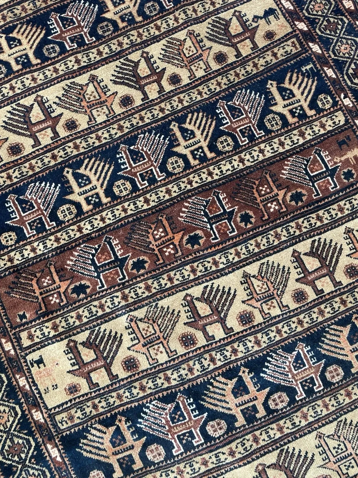 Character-rich early 20th-century Afghan tribal rug with primitive aesthetic, repeating motifs, and strong decorative impact.


