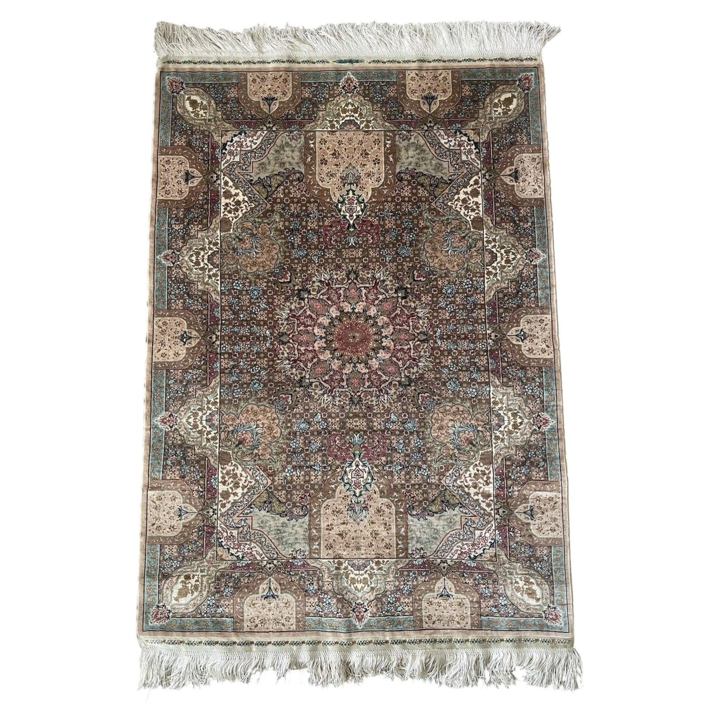 Close up view of a vintage Turkish Hereke silk rug from the 1970s featuring an intricate central medallion, floral motifs, and a soft ivory and rose color palette.


