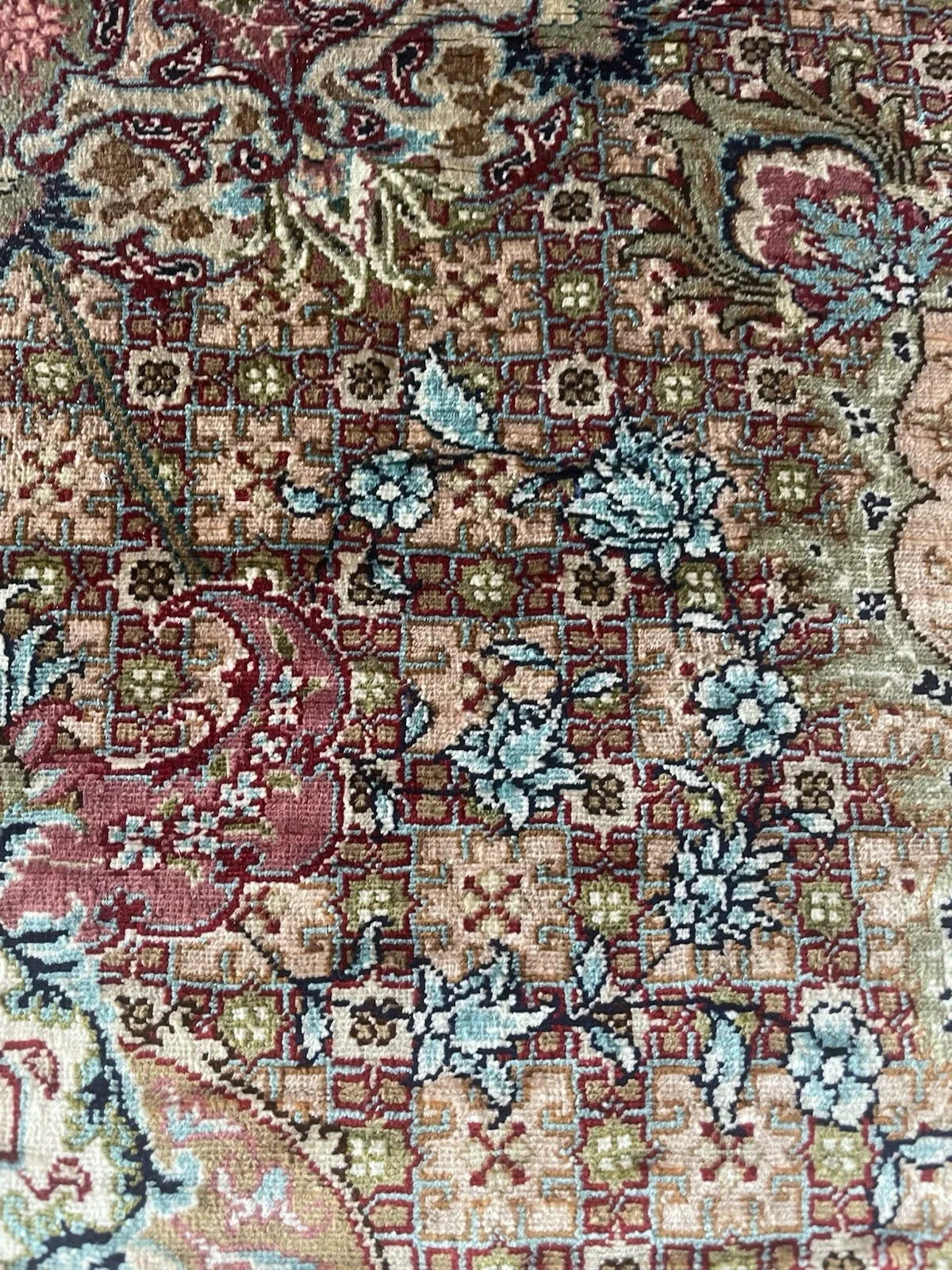 Elegant 1970s Hereke silk rug with a balanced symmetrical composition, dense floral field, and a subtle sheen that shifts with light.

