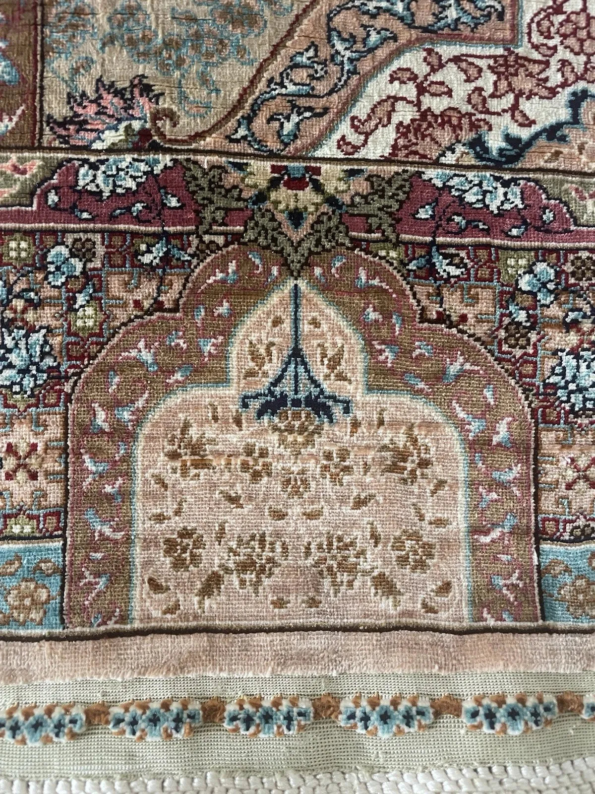 Small-scale vintage Turkish Hereke silk rug ideal for display, showing preserved colors and a detailed medallion pattern.

