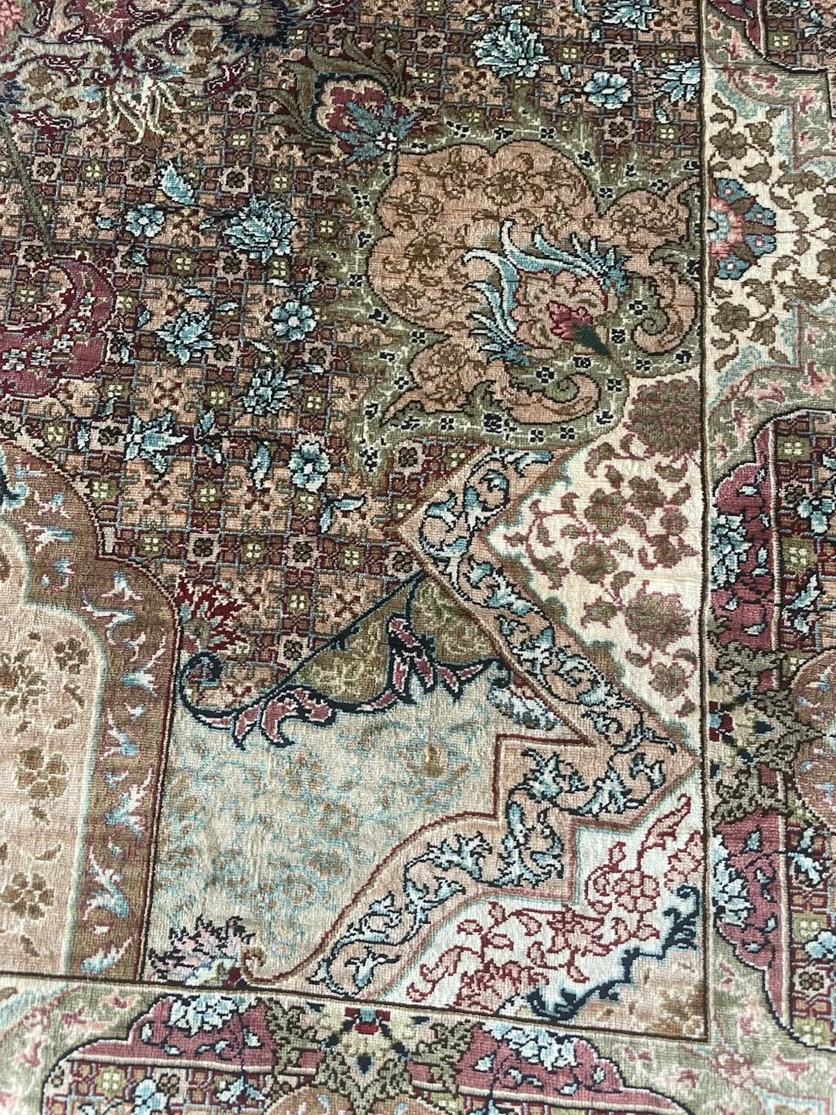 Handwoven extra fine Hereke silk rug in good vintage condition, featuring a central floral medallion and natural silk luster.

