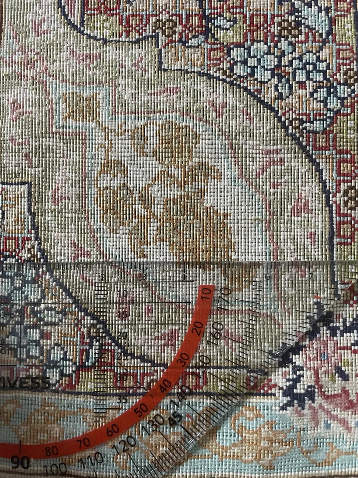 Close-up of the fringe and weave on a signed Turkish Hereke silk rug, showing intact edges and minor signs of gentle use.


