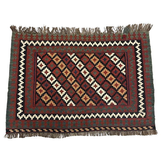 Full view of an antique Qashqai tribal bagface kilim from Persia, circa 1900, featuring an all-over diagonal diamond lattice on a jet black ground with diamonds in madder crimson, amber gold, ivory, and indigo navy.

