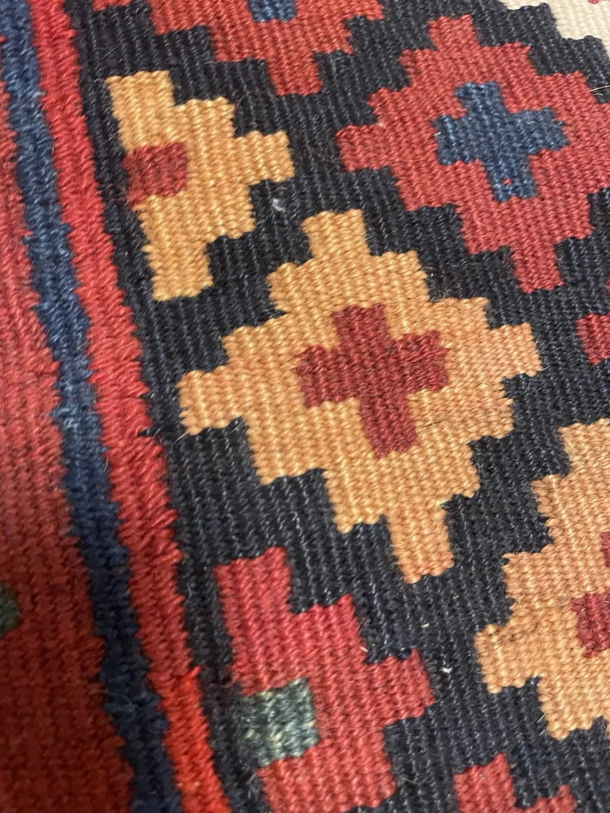 Full perspective of a collectible Qashqai bagface kilim displayed as a small flatweave, demonstrating its format as a nomadic saddlebag front panel woven with exceptional chromatic richness.

