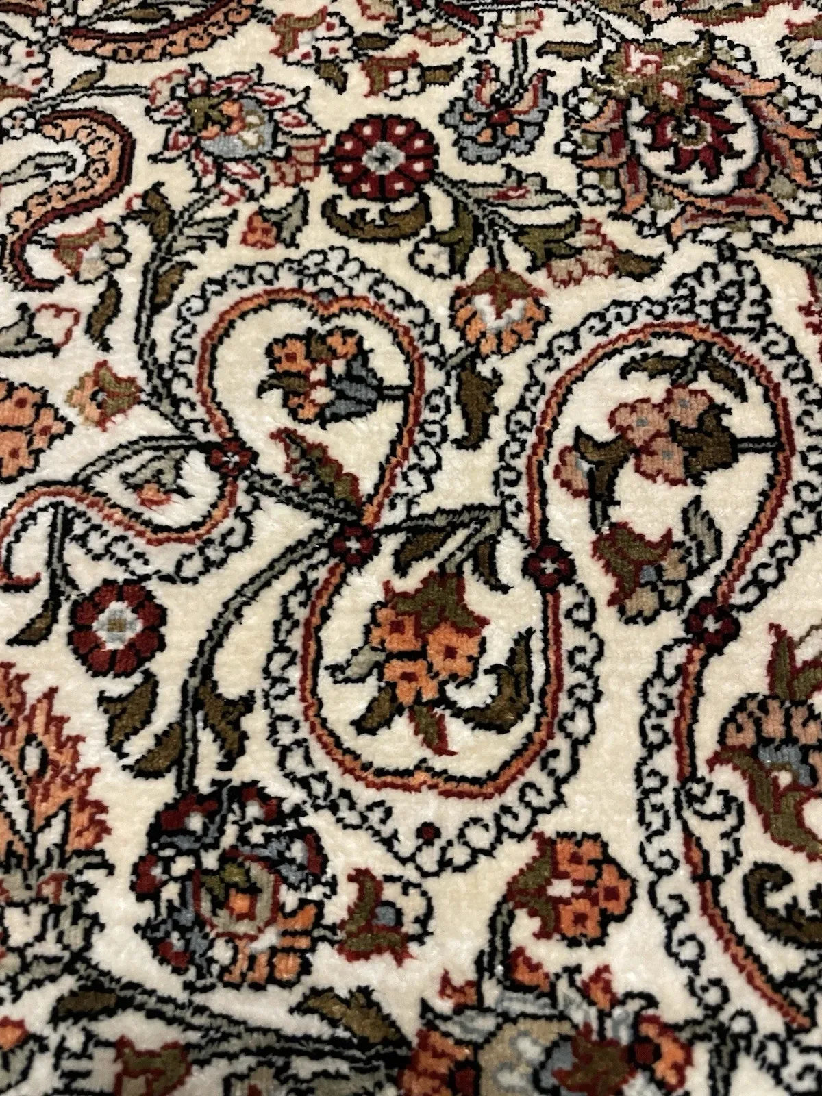 Full view of a 1970s Hereke silk prayer rug with a paradise bird perched above a double-gourd vase overflowing with flowering branches, flanked by symmetrical arabesque scrollwork in Ottoman saz style.

