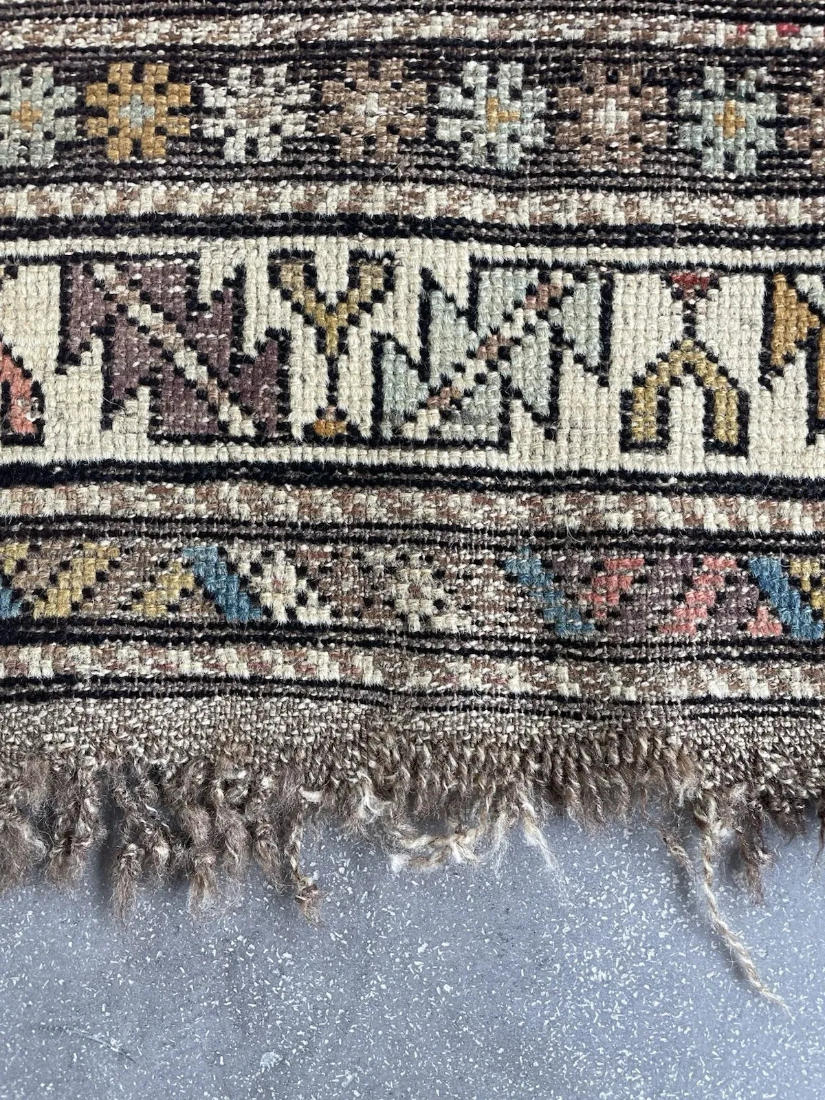 Antique Caucasian village rug from the Shirvan district (present-day Azerbaijan), circa 1900, with a bold ivory stepped cross medallion on a deep steel blue ground of extraordinary warmth.

