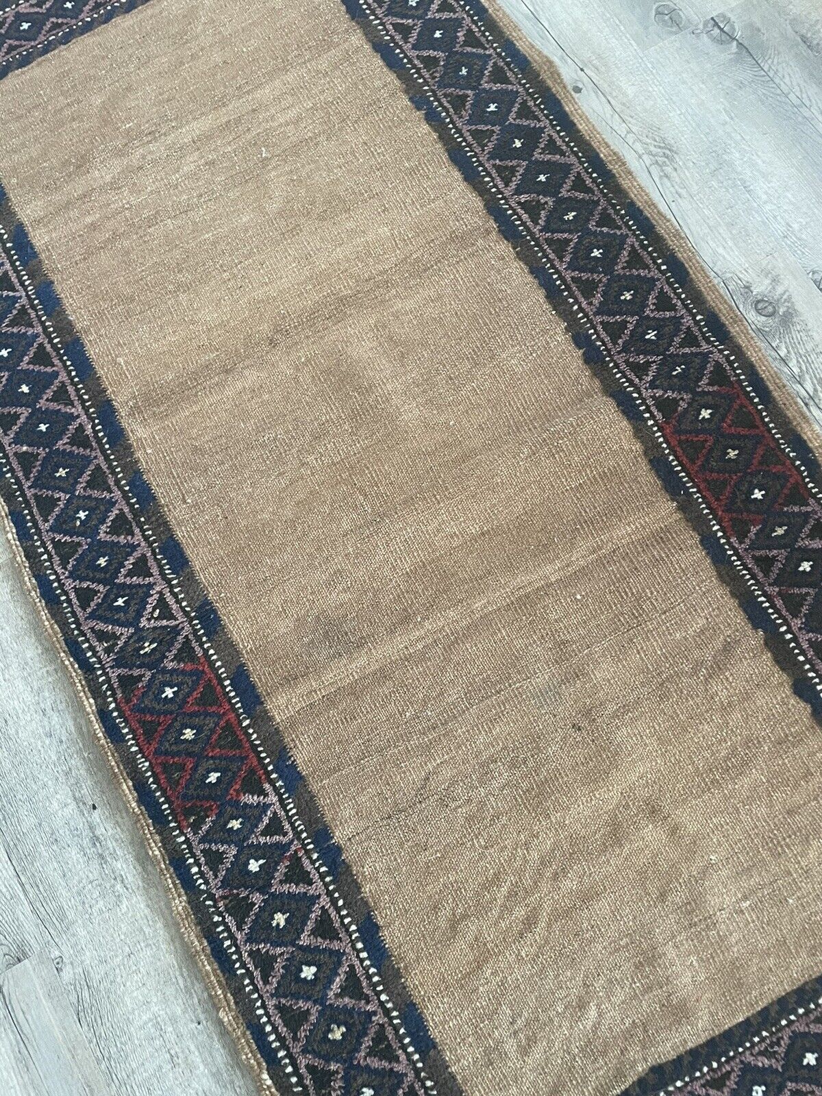 Close-up of texture on Handmade Antique Afghan Baluch Collectible Rug - Detailed view highlighting the texture of the rug, created through a combination of pile and kilim weaving techniques, adding depth and visual interest.