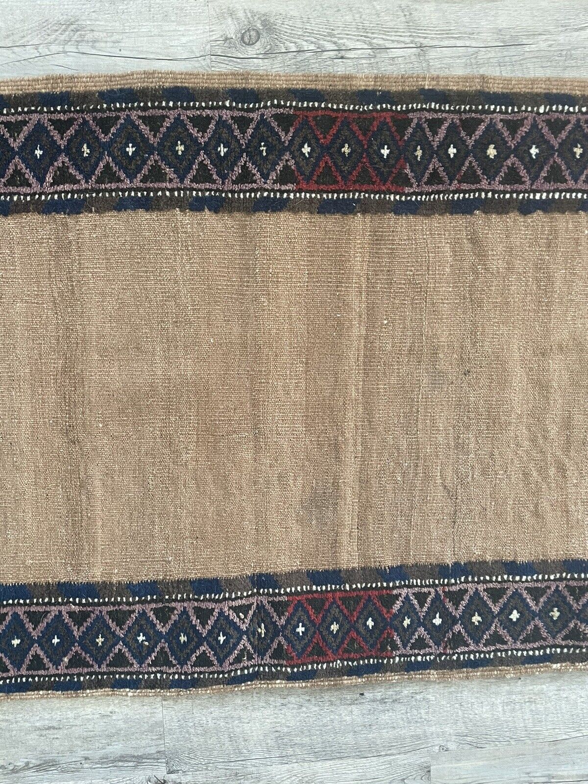 Close-up of color palette on Handmade Antique Afghan Baluch Collectible Rug - Detailed view showcasing the color palette of the rug, including red, black, and beige tones that create a harmonious visual appeal.