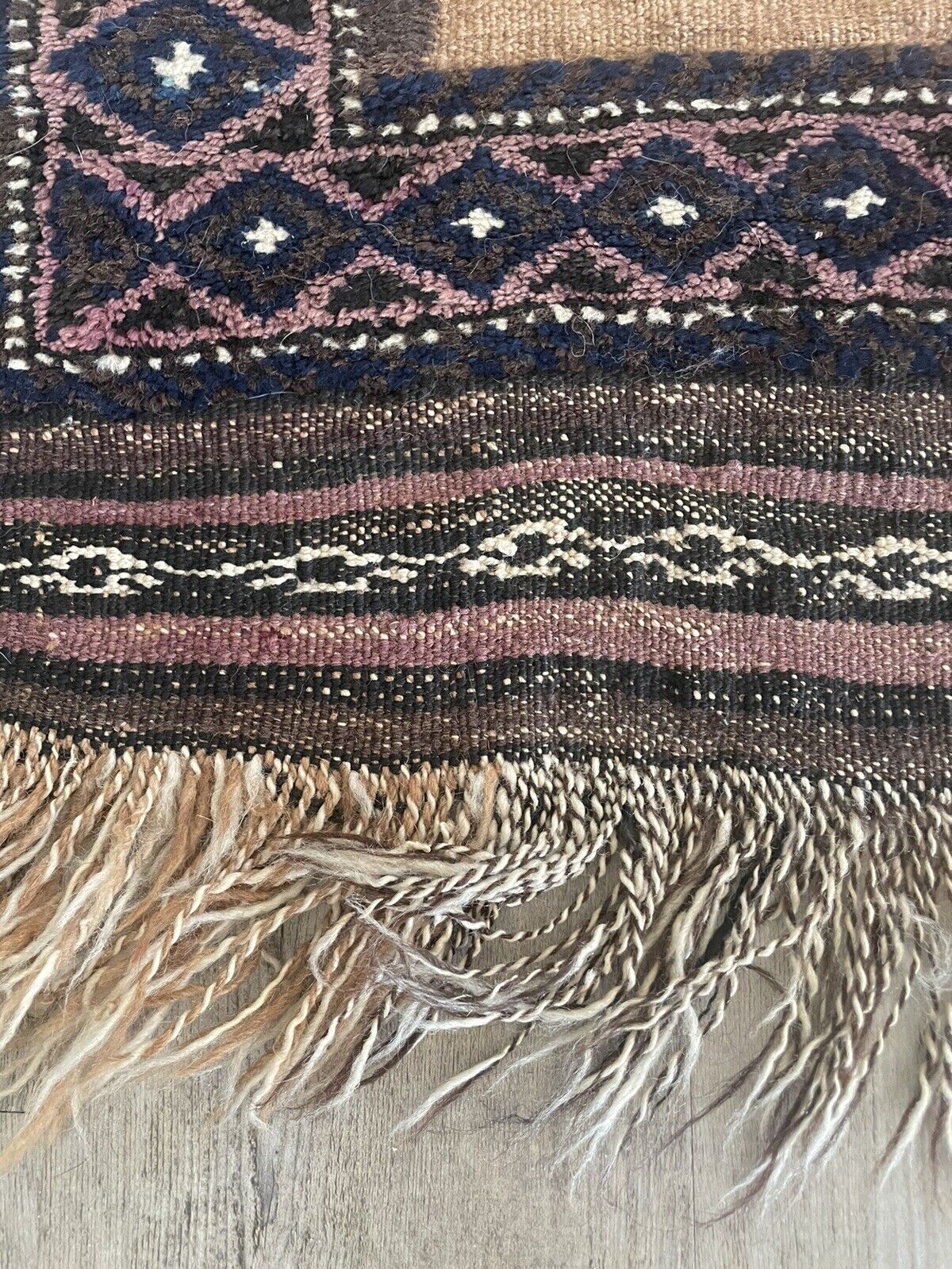 Close-up of craftsmanship on Handmade Antique Afghan Baluch Collectible Rug - Detailed view emphasizing the skillful craftsmanship evident in the rug's design and construction, despite signs of age wear.