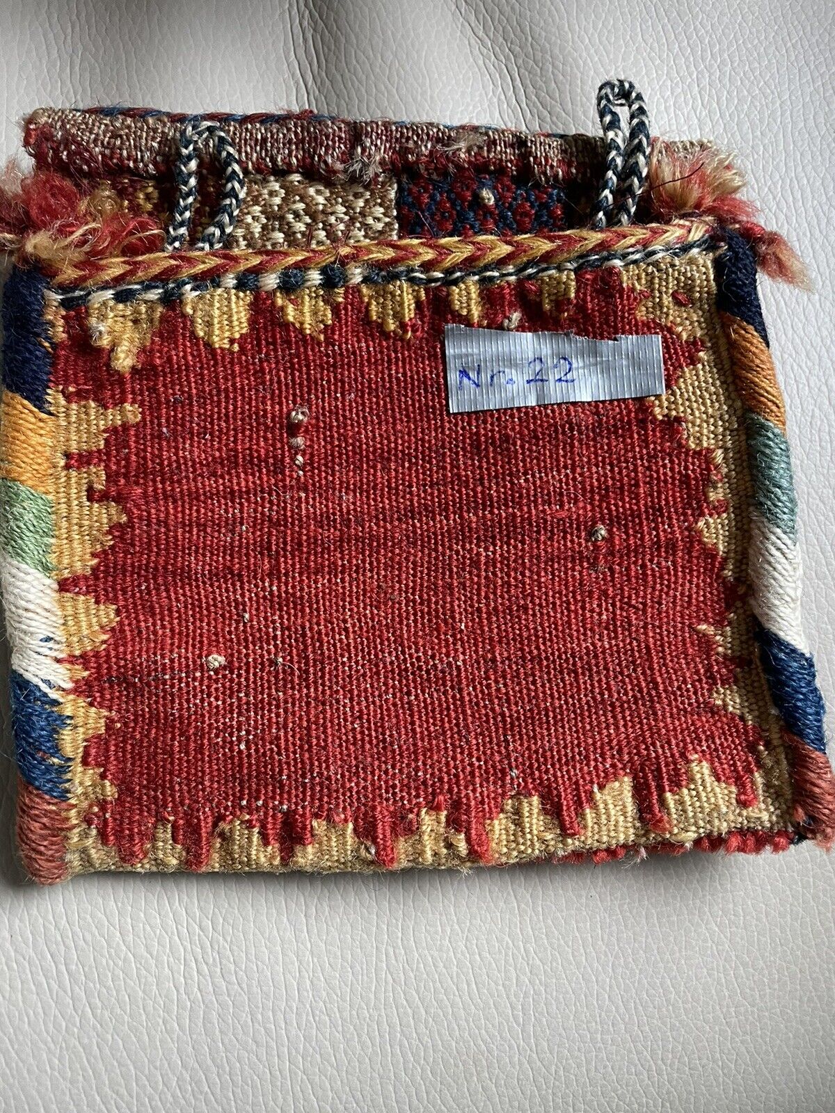 Backside of a handmade antique Persian Gashkai small bag (1900s) crafted from high-quality wool in good condition.