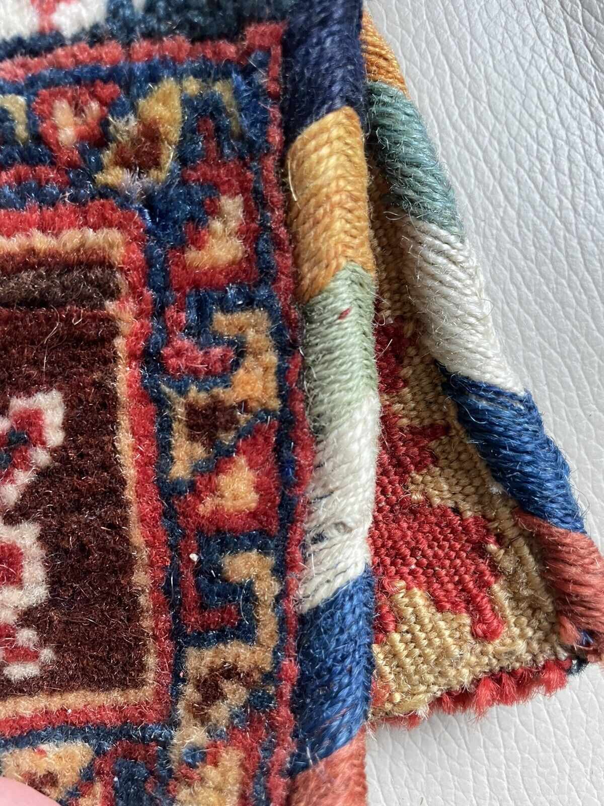 The handmade antique Persian Gashkai small bag (1900s) styled with bohemian clothing.