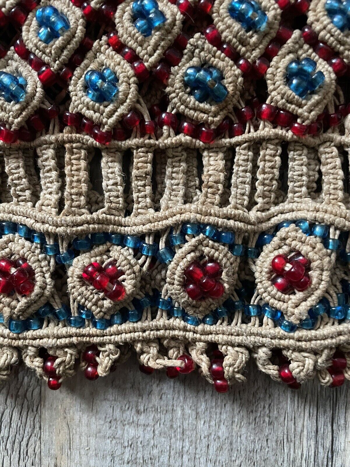 A close-up of any unique markings or variations in the beadwork, signifying the handmade nature and potential age-related characteristics of the vintage piece.