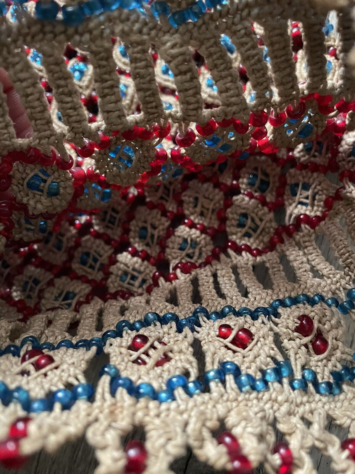 The handmade vintage Malian bag (1960s) displayed in natural light, showcasing the vibrancy of the colored beads against the natural cotton fabric.