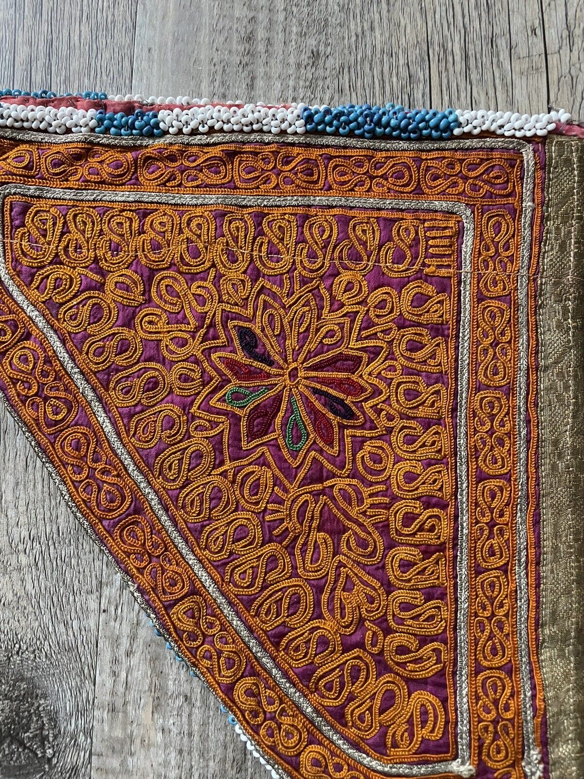 A close-up of the embroidery thread used in the handmade antique Uzbek Suzani collectible bag (1920s).