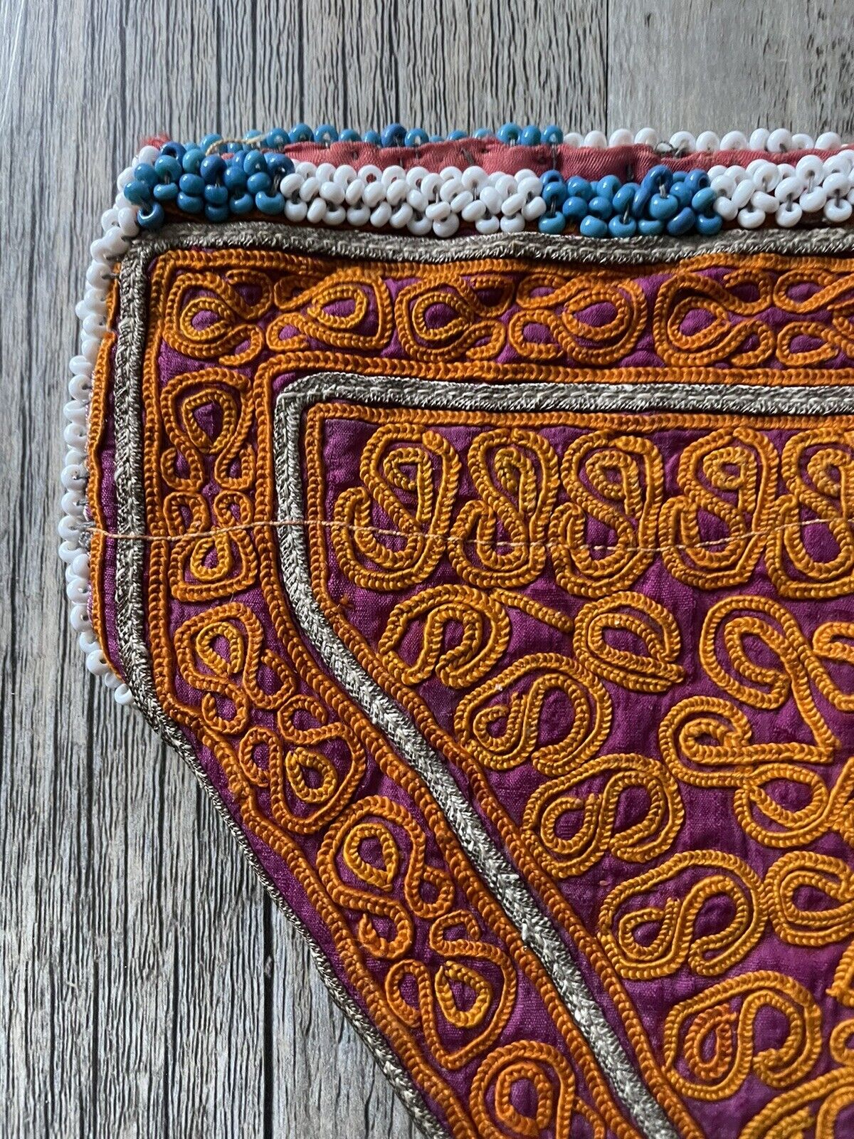A detailed view of the stitching technique used in the Suzani embroidery on the bag.