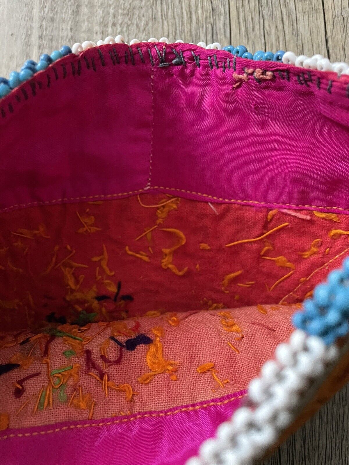 Backside of a handmade antique Uzbek Suzani collectible bag (1920s) made of cotton in good condition.