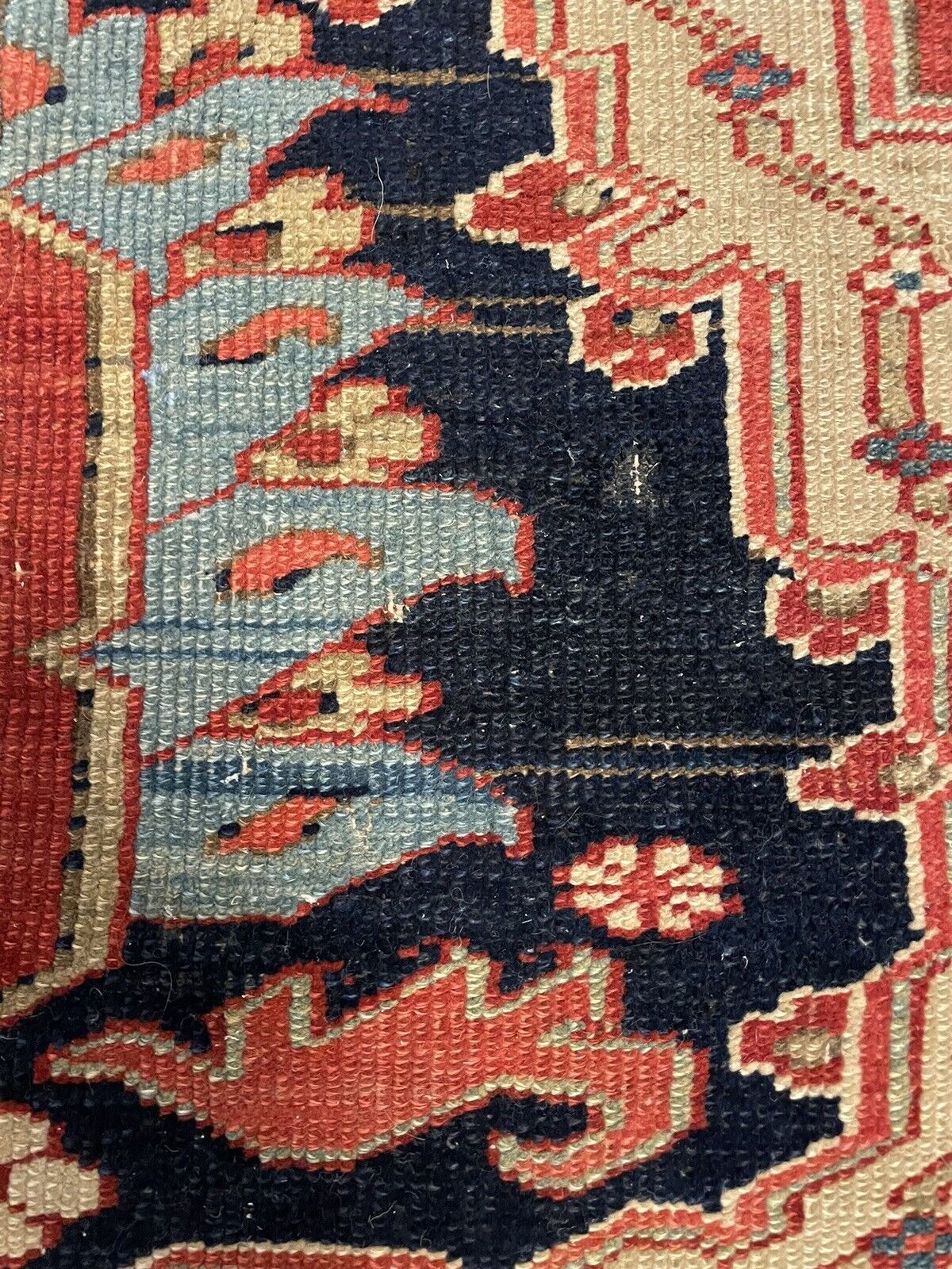 A close-up of an area with minimal wear, showcasing the rug's overall well-preserved condition for a piece from the 1880s.