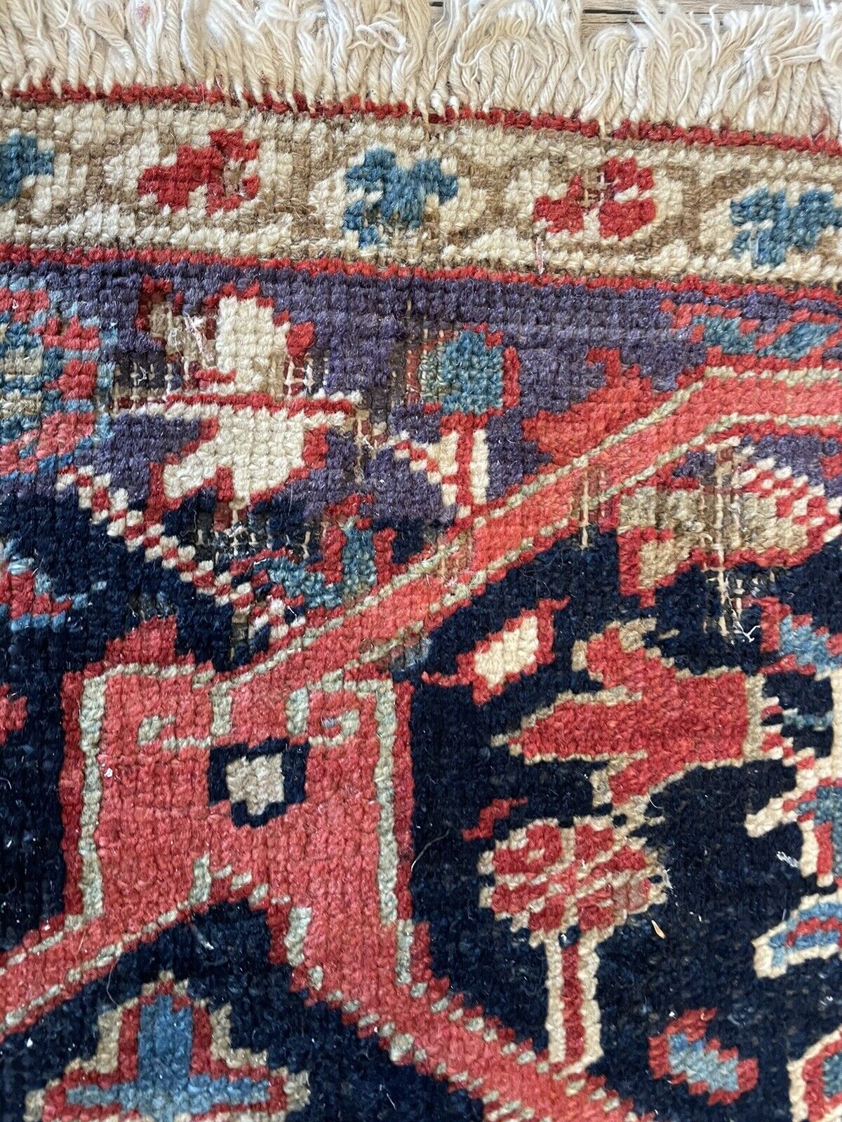 A close-up of a section with slightly more wear, highlighting the rug's natural aging process and adding to its vintage character.