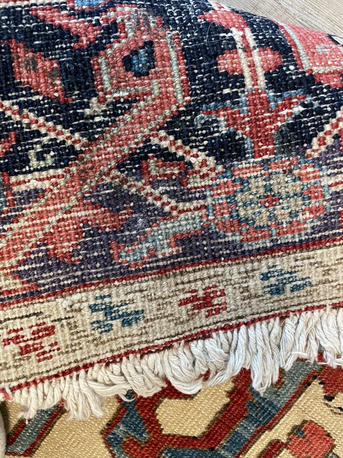 The rug displayed in a well-lit room with natural light, emphasizing the vibrancy and richness of the natural dyes.