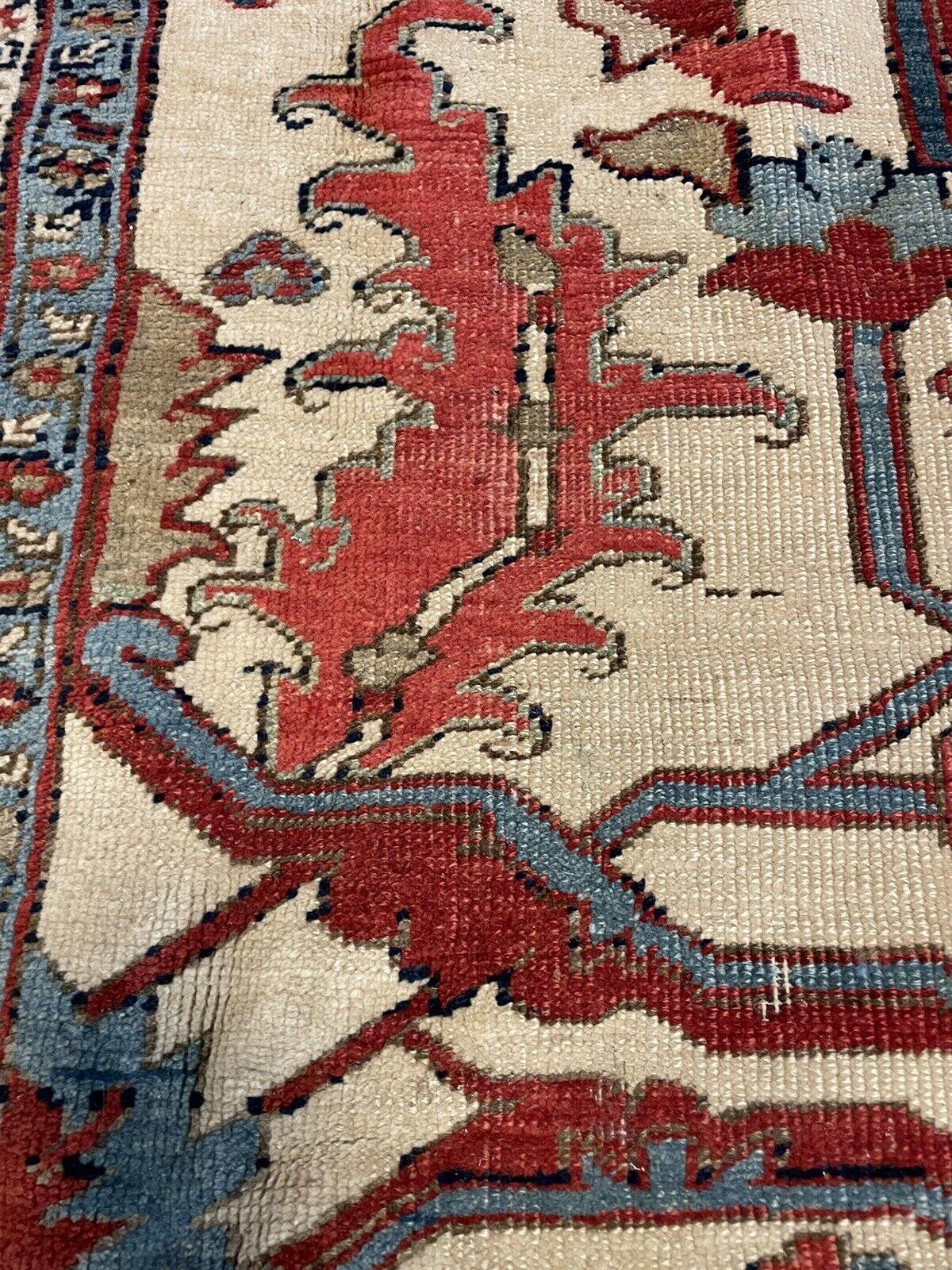 The rug rolled up and secured with traditional cloth ties, demonstrating a method for safe storage and preservation.